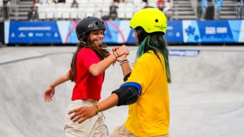 Fay De Fazio Ebert gives a high five to another skateboarder