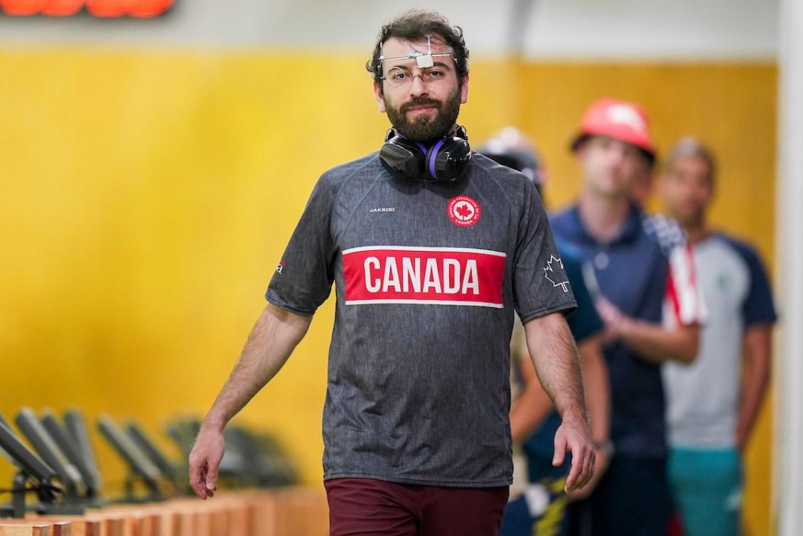 Tugrul Ozer smiles at the camera while wearing his protective glasses