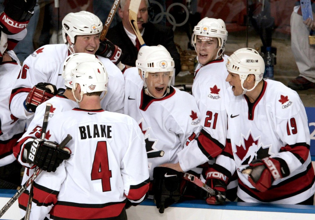 Five Canadian hockey players celebrate a goal 