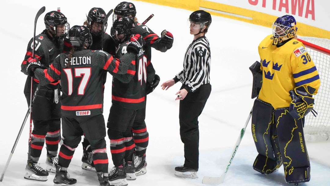 Canada's Laura Stacey celebrates her goal over Sweden goaltender Emma Soderberg with teammates during first period quarterfinal action at the IIHF Women's World Hockey Championship in Utica, N.Y., Thursday, April 11, 2024.