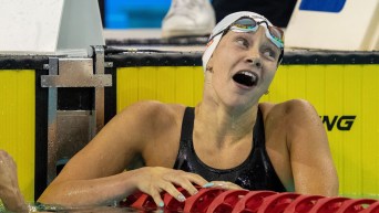 Regan Rathwell opens her mouth in disbelief as she hangs off the lane rope at the end of the pool