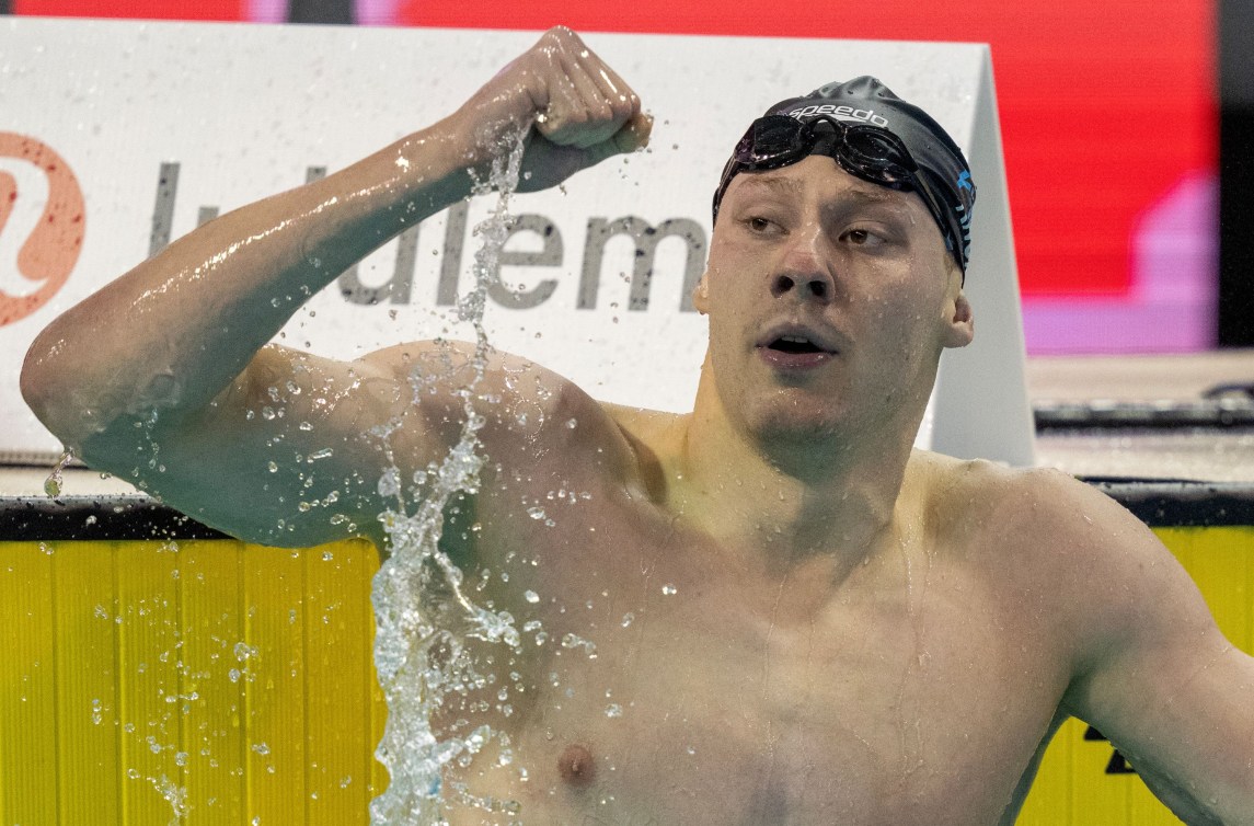 Finlay Knox pumps his fist at the end of the pool 