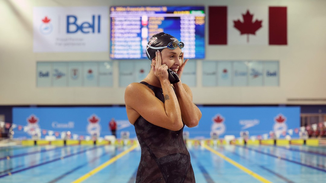 Swimmer Marie-Sophie Harvey celebrates by the pool