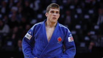 Francois Gauthier Drapeau in a blue judo outfit holds his hands on his hips