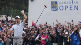 Nick Taylor tosses his golf club in the air in reacting to his win at the RBC Canadian Open
