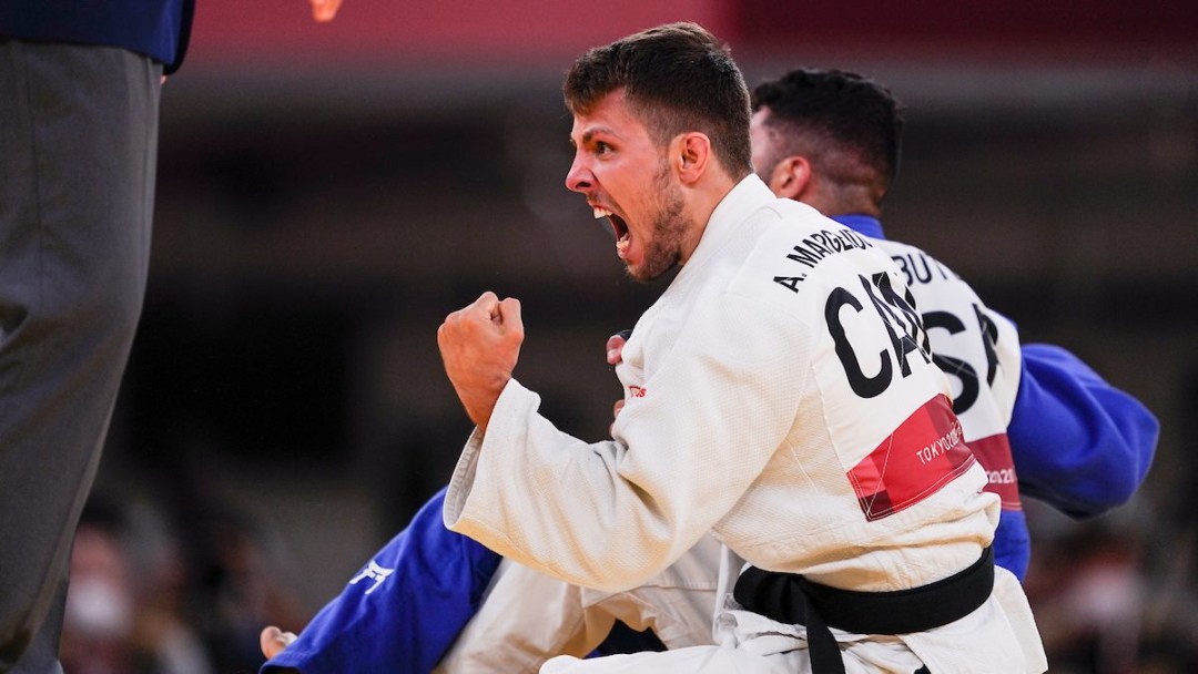 Judoka Arthur Margelidon pumps his fist in celebration