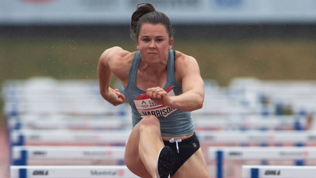 Michelle Harrison leaps over a hurdle