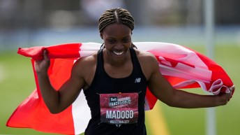 Jacqueline Madogo holds a Canadian flag behind her back