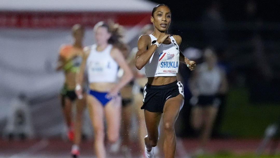 Jazz Shukla in white top and black shorts runs on a track