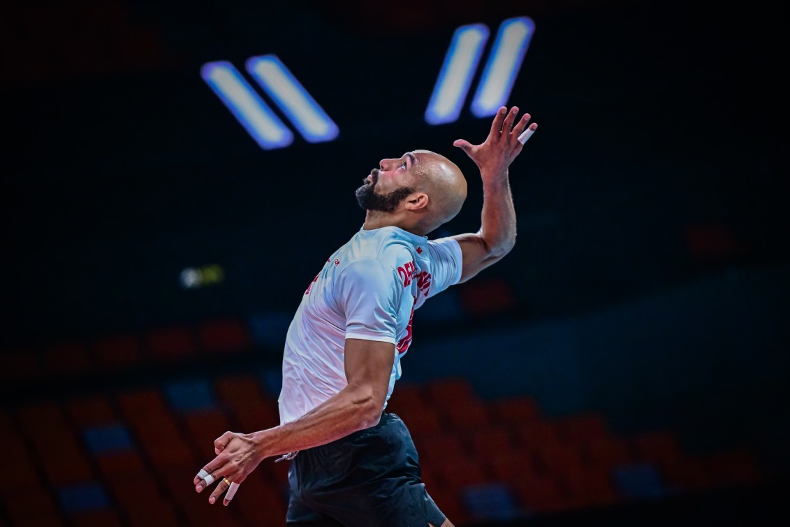 Danny Demyanenko jumps up in the air to smash the ball