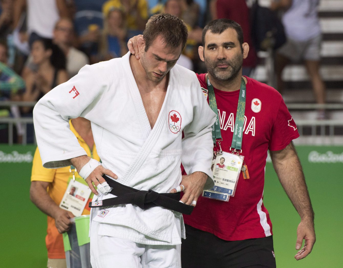 Antoine Valois-Fortier écoute les conseils de son entraîneur Nicolas Gill après sa défaite en quarts de finale des 81 kg aux Jeux olympiques de Rio, le 9 août 2016. THE CANADIAN PRESS/Ryan Remiorz