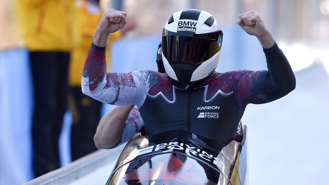 Justin Kripps et Jesse Lumsden célèbrent à la fin de leur dernière descente aux Mondiaux de bobsleigh à Königssee, en Allemagne, le 19 février 2017. (Photo : Angelika Warmuth/dpa via AP)