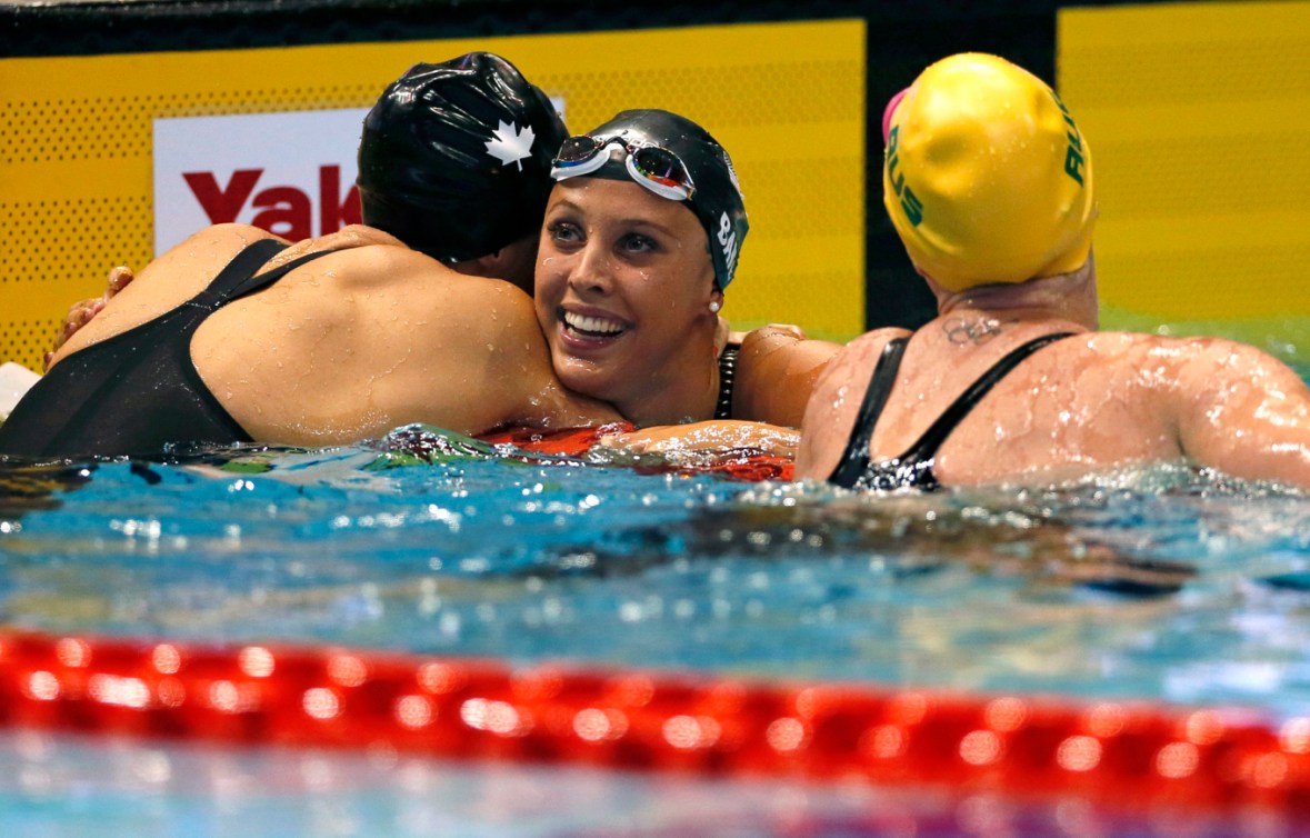 Kylie Masse, au centre, célèbre après avoir remporté le 100 m dos à Tokyo, le 10 août 2018. AP Photo/Koji Sasahara