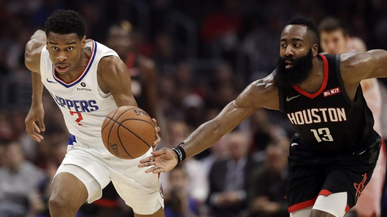 Shai Gilgeous-Alexander des Clippers de Los Angeles dribble devant James Harden lors d'un match de la NBA.